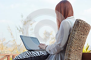 Girl working on her laptop computer outside