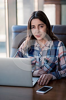 Girl working with laptop in cafe