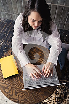 Girl working on laptop from home or student studying from home or freelancer. Online work, early in the morning desk