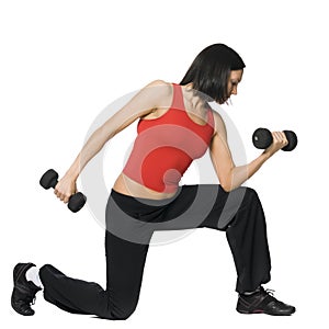 Girl is working out with dumbbells