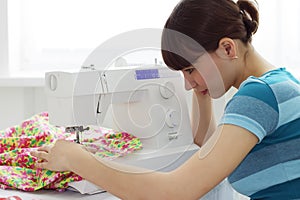 The girl works on sewing machine