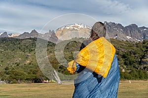 Girl wrapped in blanket with mountains