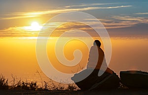 Girl Wrapped in Blanket while watching sunset