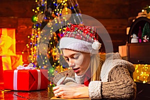 Girl write letter to Santa. Happy young lady. New year concept. Santa Claus mood. Wish List for Santa.
