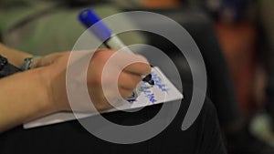 Girl writes at the event with a pencil marker on a sheet