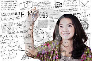 Girl writes math and science formula