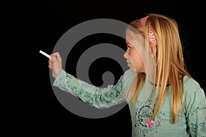 Girl writing on blackboard