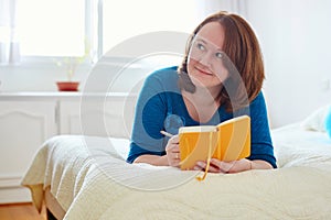 Girl writing into diary or planning her day