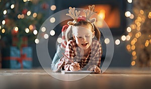 Girl is writing the letter to Santa