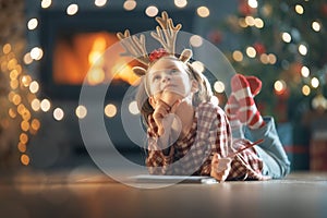 Girl is writing the letter to Santa