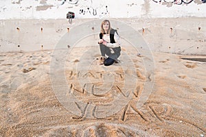 Girl Writing New Year in Sand