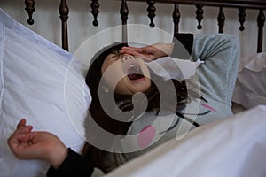 Girl yawning on bed