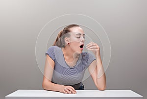 Girl yawns out of boredom or tiredness or is about to sneeze