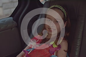 A girl of 8-10 years old rides in a car. Exploring nature, travel, family vacation