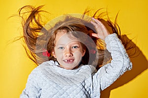 The girl on the yellow background. No front teeth. Tooth fairy and dentistry.Smiles happy.