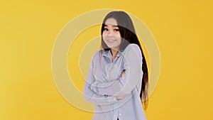 Girl on yellow background shrugging his shoulders. emotions, doubt , hesitation