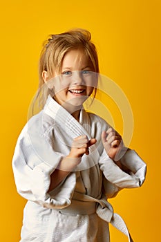 Girl on a yellow background with white belt is hitting right hand