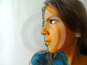 Girl with yellow face body art