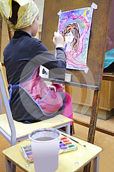 Girl in yellow scarf and apron painting fantastic