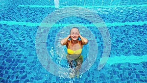 Girl in yellow swim suit in the big pool. Private propery.