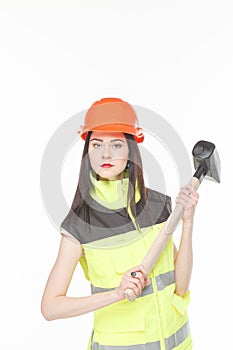 Girl in a yellow vest with the tool