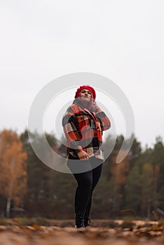 A girl on a yellowish autumn forest background.