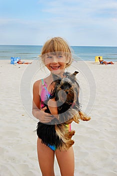 Girl with yorkshire dog on the beach