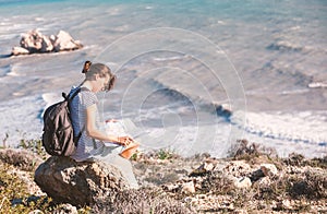 Girl young woman traveler with a backpack and map in hand walks