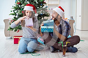 The girlfriend and boyfriend opening christmas gifts