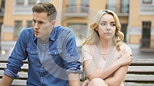 Girlfriend and boyfriend sitting next to each other angry, couple fighting photo