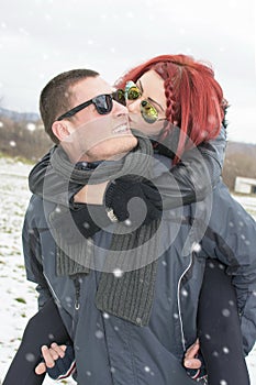 Girlfriend kissing a boyfriend on the cheek