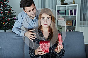 Girlfriend looks sceptical to her christmas gift photo