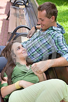 Girlfriend resting head on boyfriend's lap