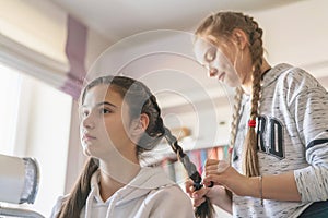 Girlfriend teen braids pigtail in room