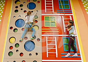 Girlfriends on climbing wall, entertainment center