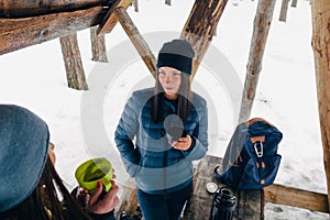 Girlfriends drink coffee talk forest winter Girlfriends relaxing