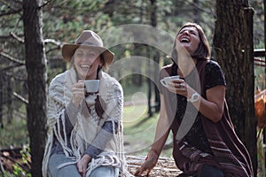 Girlfriends drinking coffee on nature in the country. Folk style