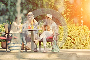 Girlfriends enjoying cocktails in an outdoor cafe, friendship concept