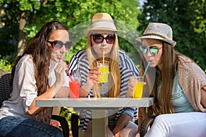 girlfriends enjoying cocktails in an outdoor cafe, friendship concept