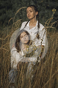 Girlfriends hug outdoors. Women hug on a green field. Smile and enjoy life. Protecting same-sex relationships