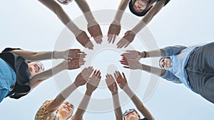 Girlfriends join the palms of their hands in the center making a circle shape.