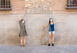 Girlfriends keeping social distancing happy to see each other. Coronavirus COVID-19 protection