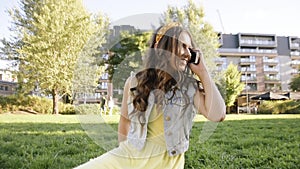 Girlfriends met by chance in the park. Girls in the park are sitting, talking, laughing, happy to meet. Longtime friends, teens,