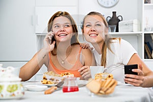 Girlfriends are playfull talking by phone