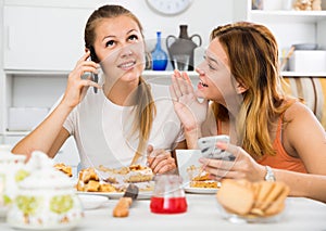 Girlfriends are playfull talking by phone