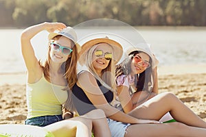 Girlfriends playing on the beach in the summer.