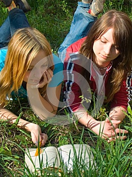 Girlfriends read book lying down