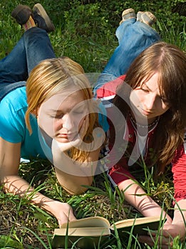 Girlfriends read book lying down