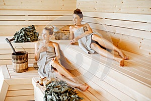 Girlfriends relaxing in the sauna