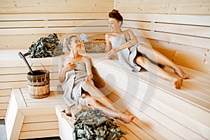 Girlfriends relaxing in the sauna